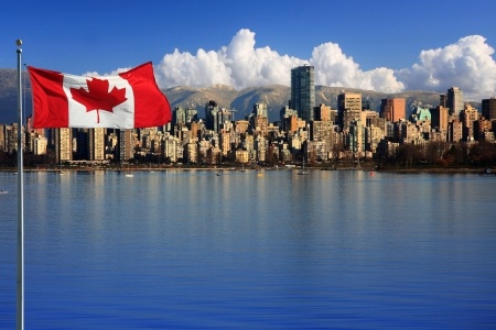 Canadian flag in front of the beautiful city of Vancouver, canada